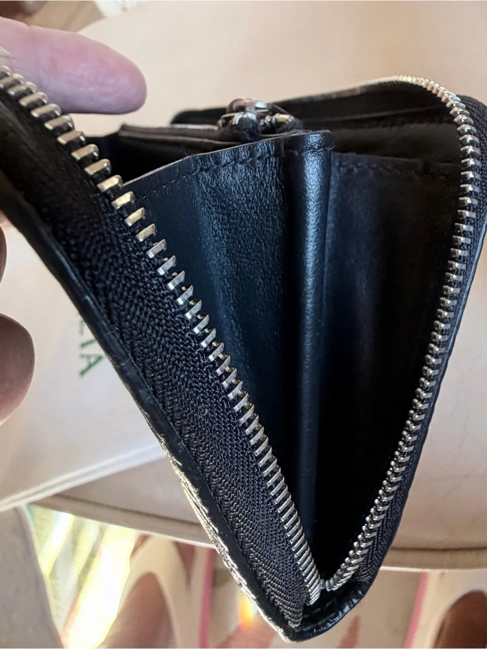 BOTTEGA VENETA Black Zip Around Wallet in Intrecciato Debossed Calfskin. UNISEX.